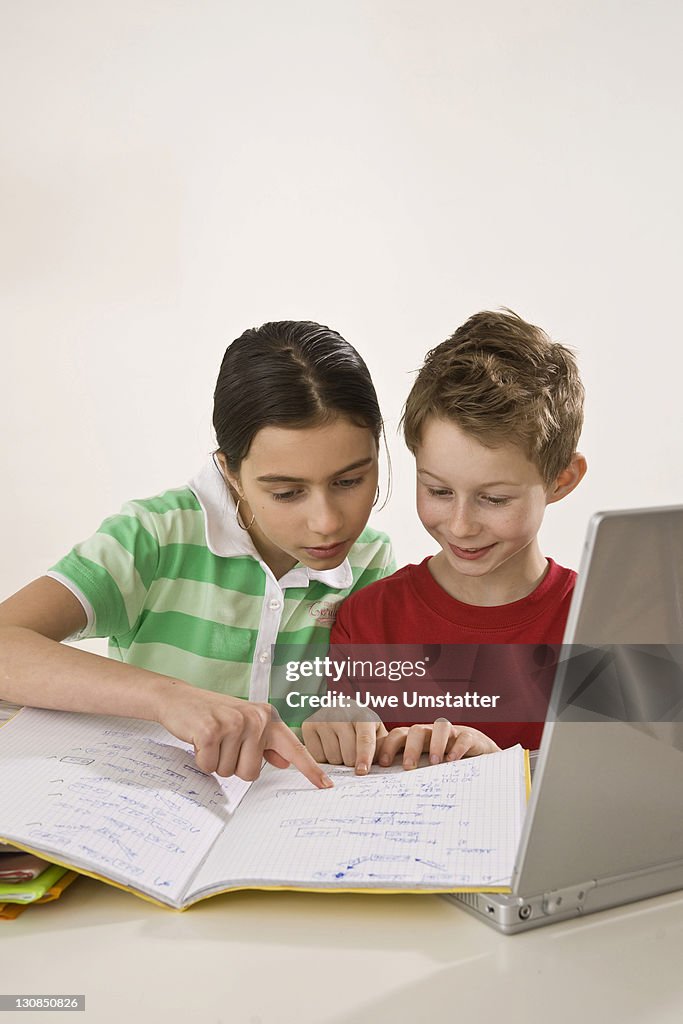 Girl helping a boy with his homework