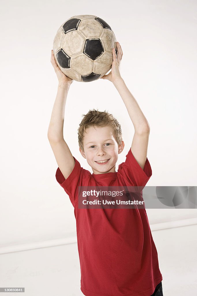 Portrait of a smiling boy with a football