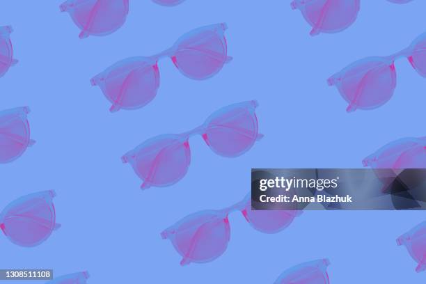 pattern made of pink neon sunglasses ober blue background. trendy 90s new wave style picture. - 90s background stock pictures, royalty-free photos & images