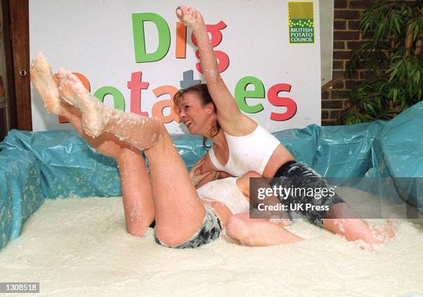 Young female wrestlers get down and dirty during a mashed potato wrestling match courtesy of the British Potato Council October 9, 2000 in London,...