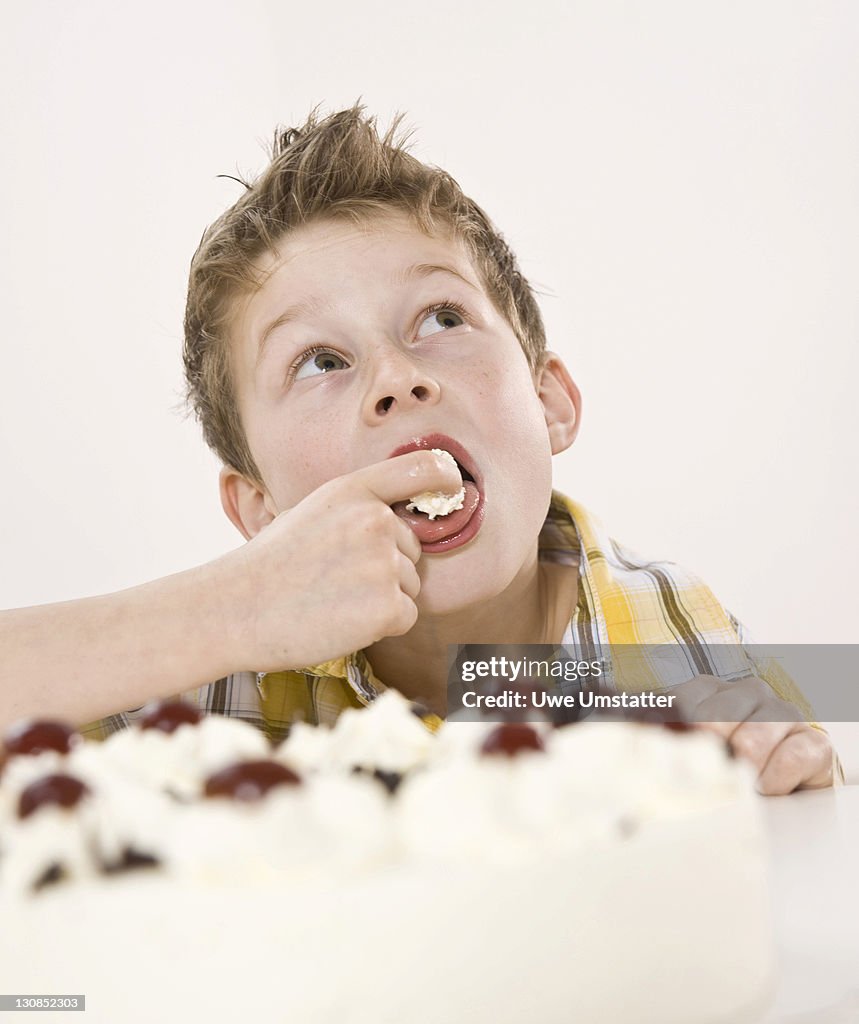 Boy eating a piece of Black Forest Cake