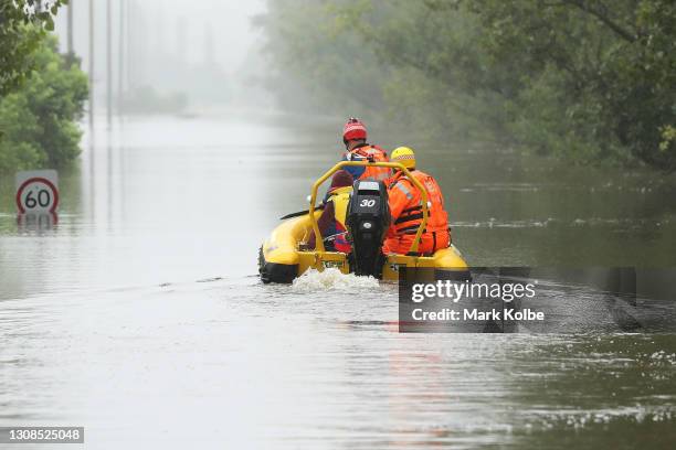 State Emergency Service workers drive their rescue craft through the flooded Hawkesbury river along Inalls lane in Richmond on March 23, 2021 in...