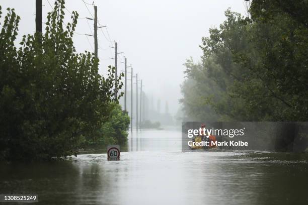 State Emergency Service workers drive their rescue craft through the flooded Hawkesbury river along Inalls lane in Richmond on March 23, 2021 in...