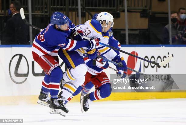 Adam Fox of the New York Rangers hits Jeff Skinner of the Buffalo Sabres during the third period at Madison Square Garden on March 22, 2021 in New...