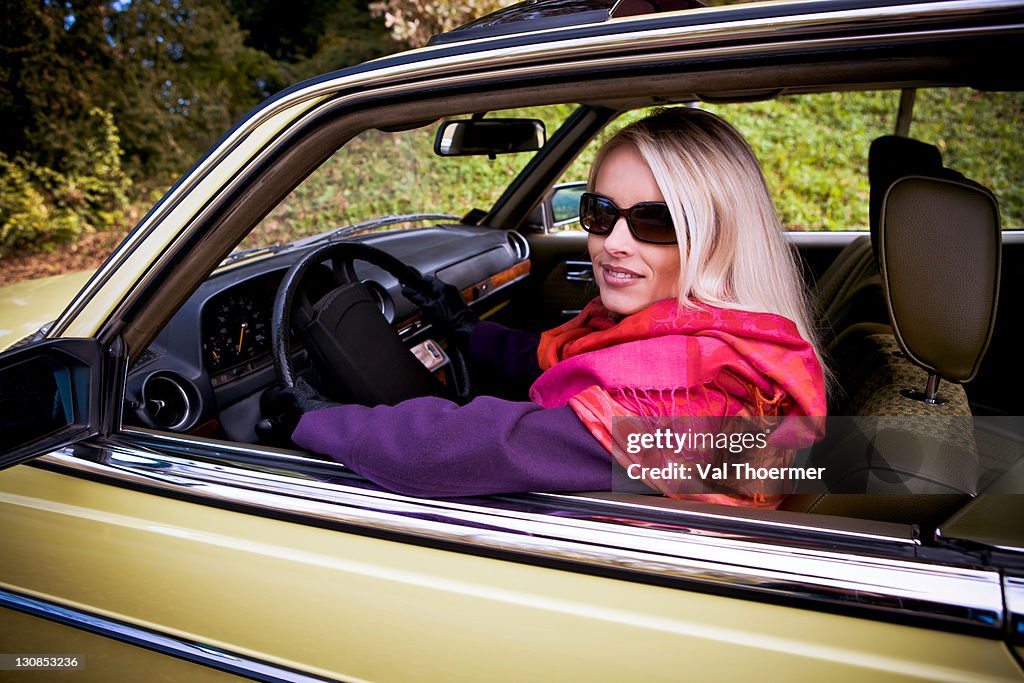Young woman in a post-war classic car