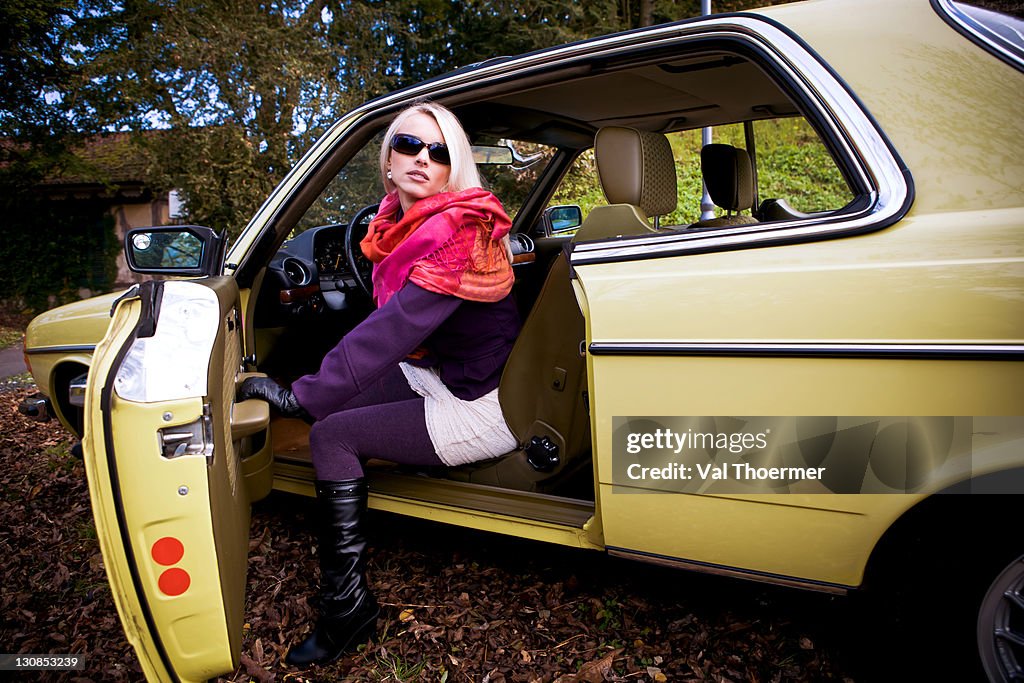 Young woman in a post-war classic car
