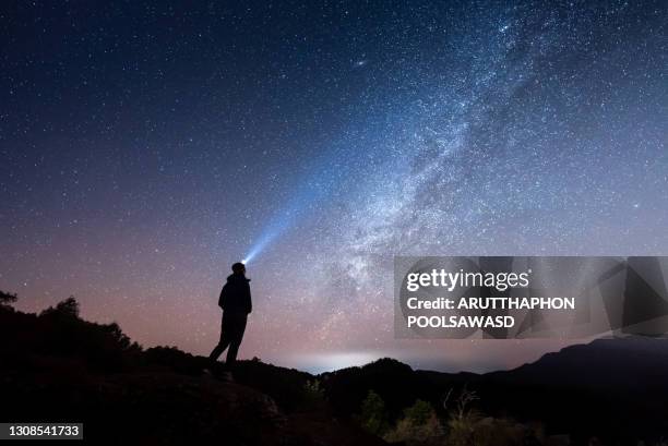 woman standing under the milky way galaxy - wide sky stock pictures, royalty-free photos & images