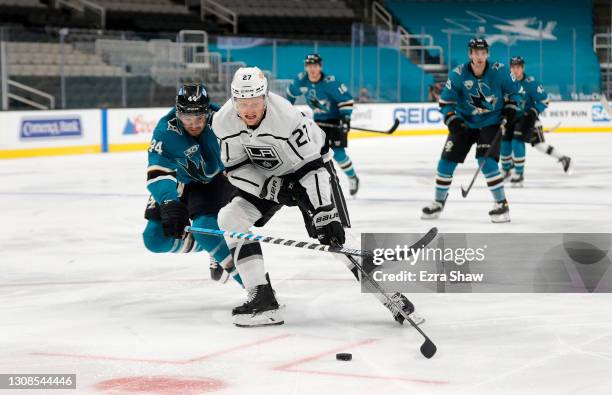 Austin Wagner of the Los Angeles Kings and Marc-Edouard Vlasic of the San Jose Sharks go for the puck in the second period at SAP Center on March 22,...