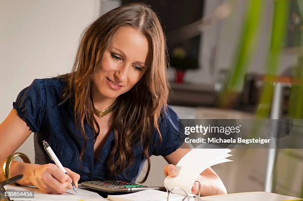 young woman controlling her finances - releasing money stock pictures, royalty-free photos & images