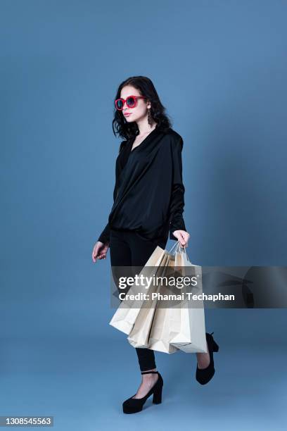 fashionable woman with shopping bags - asian fashion model stock pictures, royalty-free photos & images