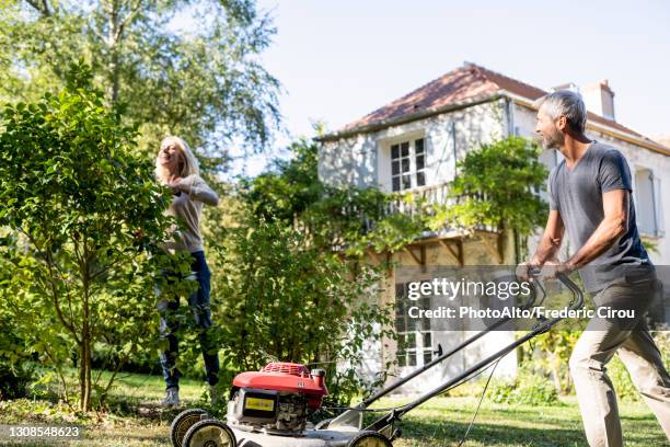 mature couple gardening together in backyard - grass cut out stock pictures, royalty-free photos & images