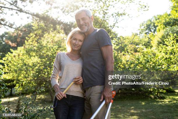 portrait of mature couple standing in backyard - 50 59 years home stock pictures, royalty-free photos & images