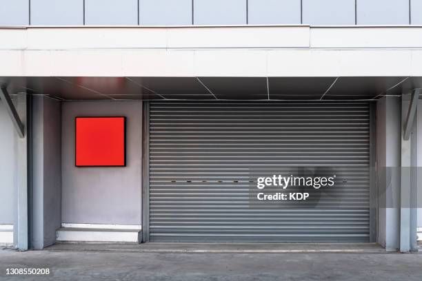 steel shutter rolling door of factory warehouse workshop for materials storage, front view of rolling metal doors for access and security. gate building structure of warehouses - city gate bildbanksfoton och bilder