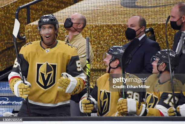 Keegan Kolesar, Patrick Brown and Reilly Smith of the Vegas Golden Knights celebrate on the bench after Kolesar scored his first NHL goal in the...