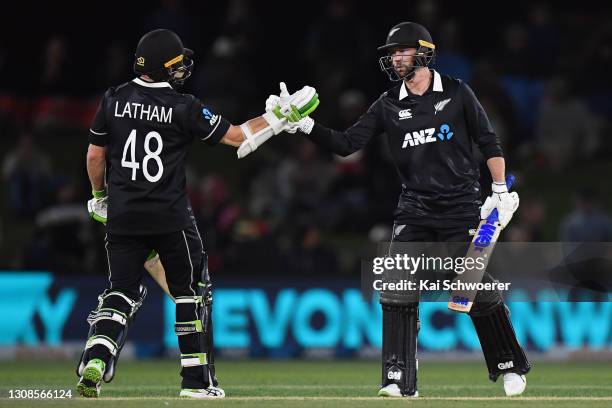 Devon Conway of New Zealand is congratulated by Tom Latham of New Zealand after scoring a half century during game two of the One Day International...