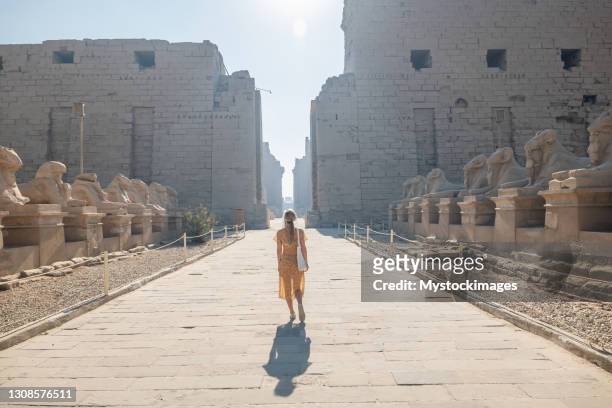 woman explores temple in luxor, egypt - temples of karnak stock pictures, royalty-free photos & images