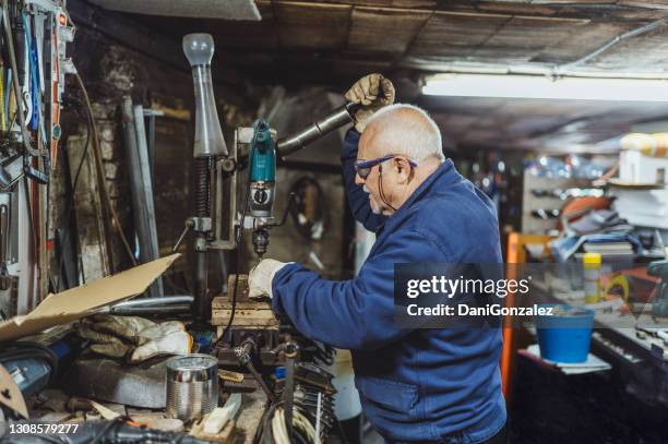 a man working in his workshop - old man working stock pictures, royalty-free photos & images