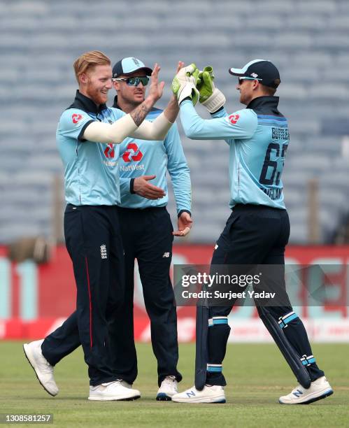 Ben Stokes of England celebrates with Jason Roy and Jos Buttler after dismissing Rohit Sharma of India during 1st One Day International between India...