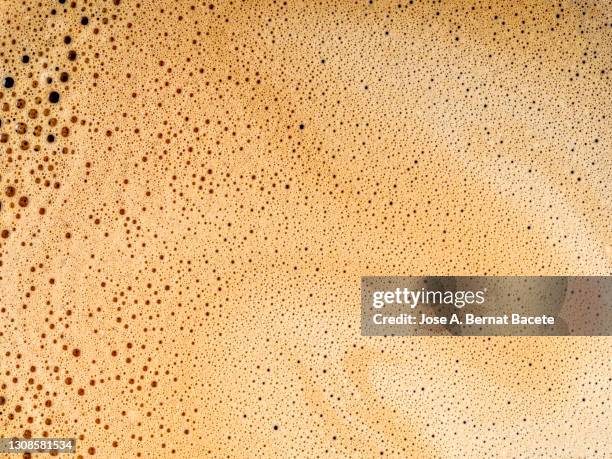 full frame of a cup of freshly made coffee with milk, backgrounds. - yellow milk stock-fotos und bilder