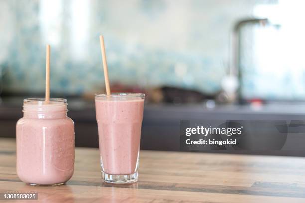 two smoothie glasses with paper straws and copy space - milkshake stock pictures, royalty-free photos & images