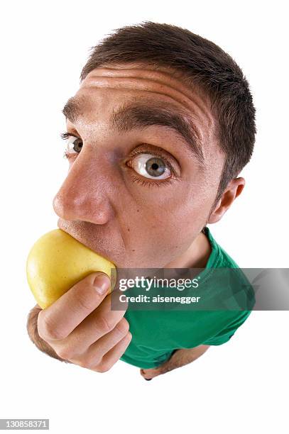 man biting into an apple, fish-eye lens - wide angle lens portrait fotografías e imágenes de stock