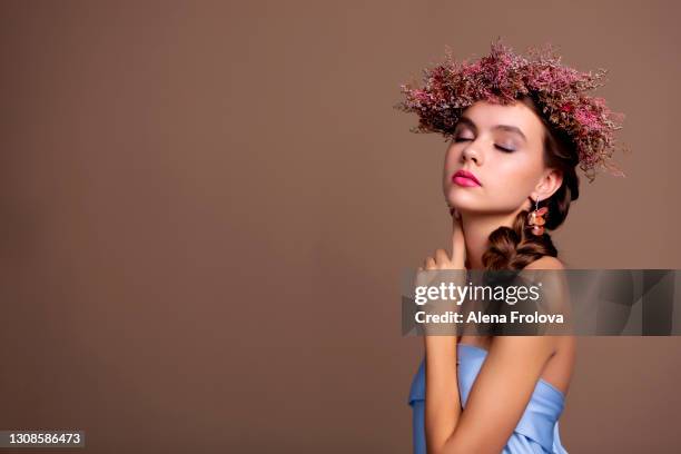beautiful young woman with wreaths and hair braided - alena model stockfoto's en -beelden