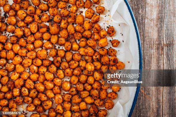 flat lay roasted spicy snack chickpeas in tray - roasted stock pictures, royalty-free photos & images