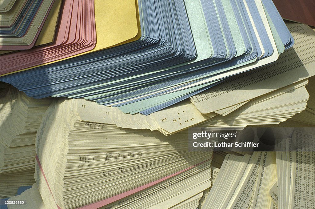 Heap of thrown away perforated cards (punched cards, punchcards)