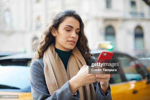 een jonge onderneemster sms'te op straat. - taxi españa stockfoto's en -beelden