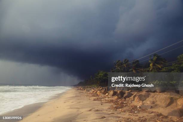 monsoon clouds over indian beach - monsoon stock pictures, royalty-free photos & images