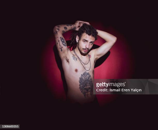 dreadlocks and tattooed man taking a picture - marijuana tattoo stock pictures, royalty-free photos & images