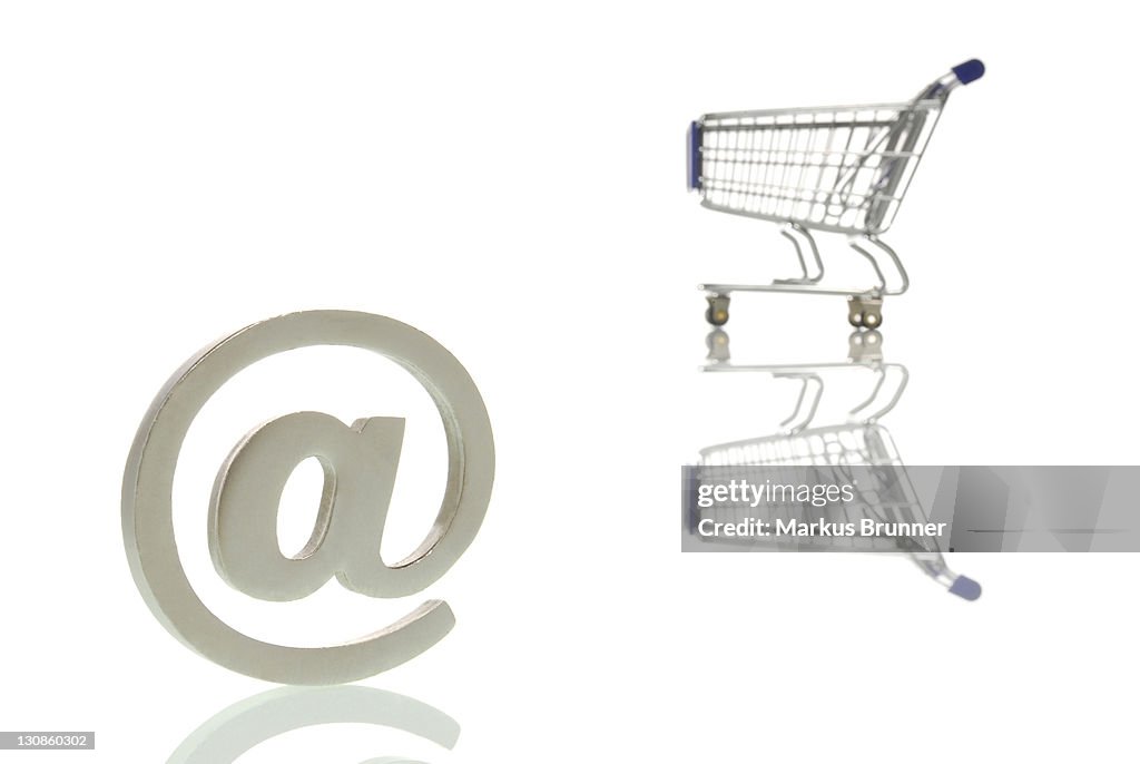 @ or at symbol with a shopping trolley, symbolic image for internet shopping