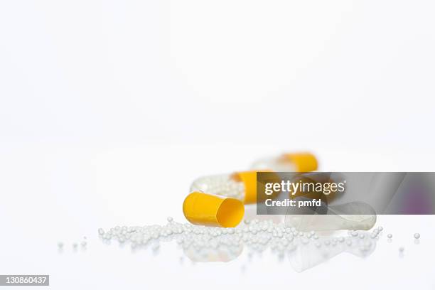 pills on a white surface - drug misuse stock-fotos und bilder