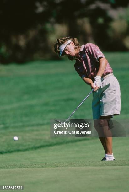 Rosie Jones of the United States watches the ball following her chip onto the green during the 25th edition of the 1997 du Maurier Classic golf...