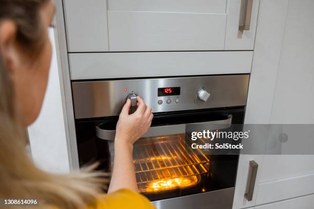 turning the oven on - oven stock pictures, royalty-free photos & images