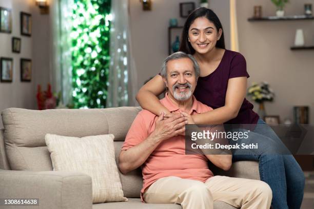 daughter embracing her father at home :- stock photo - daughter stock pictures, royalty-free photos & images