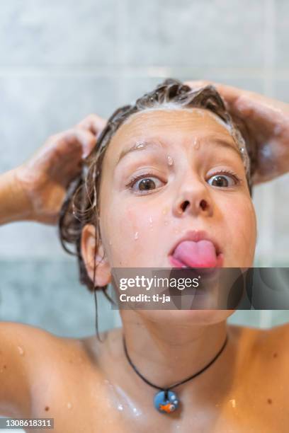 little girl washing her hair in a bathroom - tongue stock pictures, royalty-free photos & images