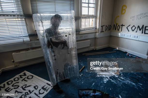 One of the squatters with a riot shield found inside the building on March 22, 2021 in London, England. Activists have occupied the former Clapham...