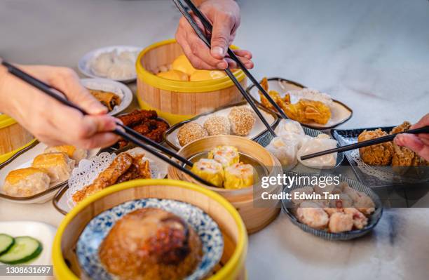 human hand using chopstick picking up tradition chinese food dim sum - dim sum meal stock pictures, royalty-free photos & images