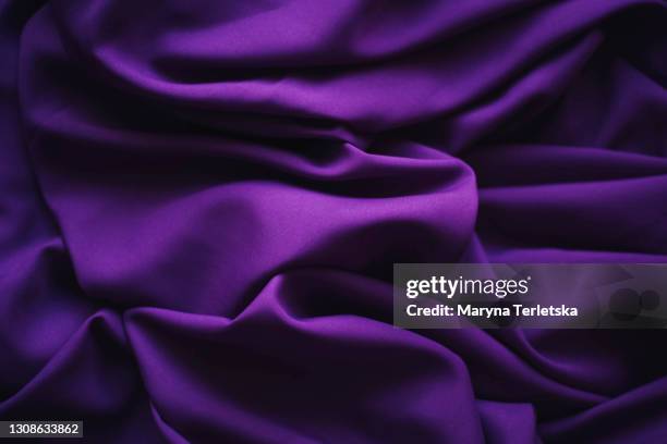 Abstract background from textured purple fabric.