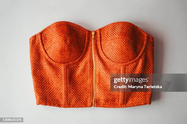 women's orange top on a gray background. - corsé fotografías e imágenes de stock