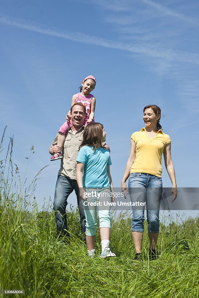 Family walking relaxed in a flower meadow