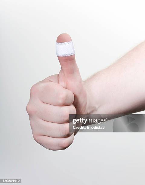 thumbs up with a plaster - bandaged thumb stock pictures, royalty-free photos & images
