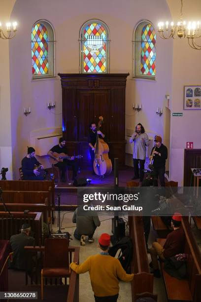 Members of the Fraenkelufer Synagogue Jewish community watch the Berlin-based Sistanagila band of Israeli and Iranian musicians recording a concert...