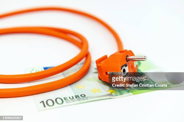 electric plug on 100 euro banknote white background - vitality bildbanksfoton och bilder