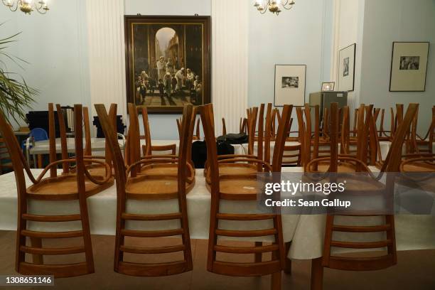 Chairs lie stacked on tables in the community room at the Fraenkelufer Synagogue prior to Passover during the third wave of the coronavirus pandemic...