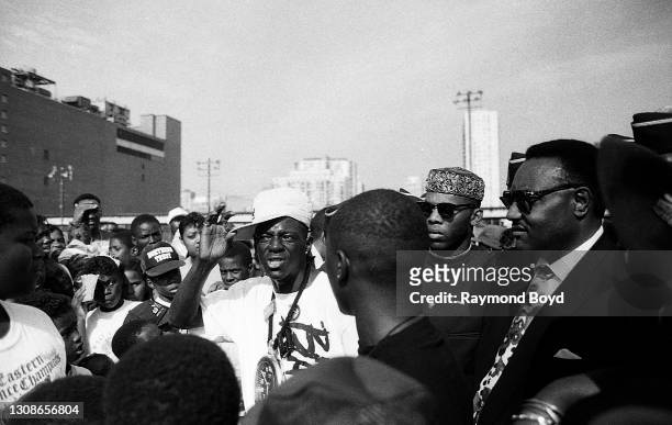 Rapper Flavor Flav of Public Enemy mingles and chats with fans outside the Cabrini-Green housing projects in Chicago, Illinois in July 1991.