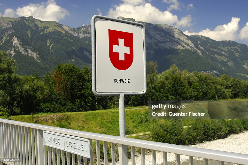 Swiss border sign on the Rhine river bridge, national border Switzerland, Principality of Liechtenstein