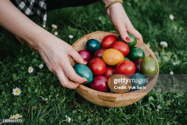 easter basket with colourful eggs - easter egg basket stock pictures, royalty-free photos & images