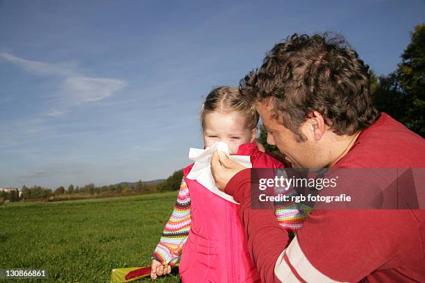 father blowing his three-year-old daughter's nose - 2 year old blonde girl father stock-fotos und bilder